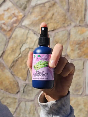 A bottle of organic lemongrass hydrosol in hand