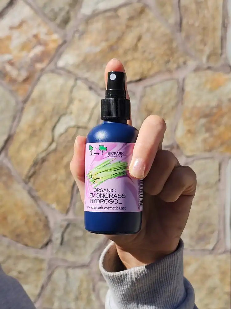 A bottle of organic lemongrass hydrosol in hand