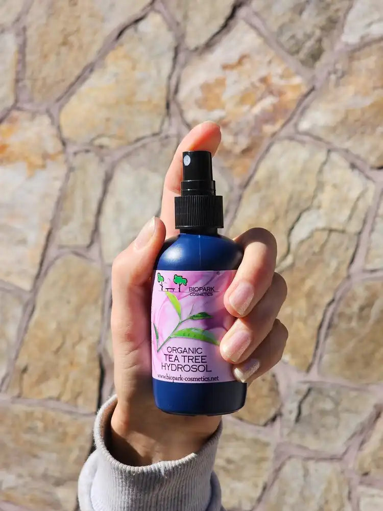 A bottle of organic tea tree hydrosol in hand