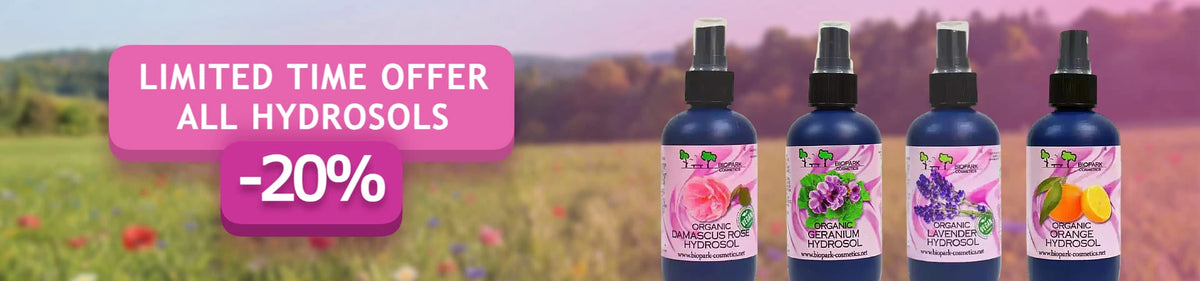 Four bottles of hydrosol perfume oils lined up on the right side of a promotional banner with a pink 'LIMITED TIME OFFER ALL HYDROSOLS -20%' text overlay on the left, set against a blurred outdoor field background.