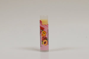 Lip balm with a colorful label featuring fruits on a white background