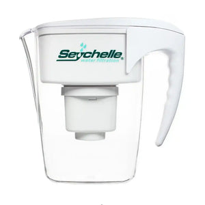 A Seychelle water filter pitcher with a clear plastic body, white lid and handle, and a white filter cartridge inside. The Seychelle brand logo is printed in green and blue on the front of the white lid.