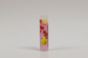 Lip balm with strawberry and lemon flavor on a white background